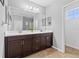 Bathroom with double sink vanity, dark wood cabinets, and a large mirror offering ample counter space at 4509 Golden Gate Cv, Bradenton, FL 34211