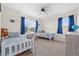 Shared ' bedroom featuring two beds, windows with curtains, and neutral walls at 4509 Golden Gate Cv, Bradenton, FL 34211