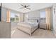 Primary bedroom with neutral walls, carpet, ceiling fan and large windows providing natural light at 4509 Golden Gate Cv, Bradenton, FL 34211