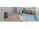 Spacious bonus room featuring carpeted floors, a large window, and storage bins at 4509 Golden Gate Cv, Bradenton, FL 34211