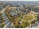 A meandering road surrounds an enormous park with tennis courts, playgrounds, and wide open spaces at 4509 Golden Gate Cv, Bradenton, FL 34211