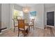 Cozy dining area with a modern chandelier and a view of the backyard at 4509 Golden Gate Cv, Bradenton, FL 34211