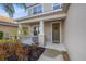 Inviting front porch with decorative columns and a charming wreath on the front door at 4509 Golden Gate Cv, Bradenton, FL 34211