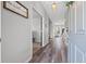 Inviting hallway with wood-look flooring, showing an open floor plan leading to a bright living room at 4509 Golden Gate Cv, Bradenton, FL 34211