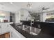 Kitchen island with stainless steel sink and black granite countertops at 4509 Golden Gate Cv, Bradenton, FL 34211