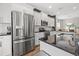 Spacious kitchen with stainless steel refrigerator, white cabinets and dark countertops at 4509 Golden Gate Cv, Bradenton, FL 34211