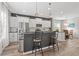 Modern kitchen with stainless steel appliances, white cabinets, breakfast bar, and dining area at 4509 Golden Gate Cv, Bradenton, FL 34211