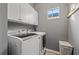 Laundry room with white washer and dryer and white cabinets at 4509 Golden Gate Cv, Bradenton, FL 34211