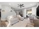 Bright and airy living room with hardwood floors, ceiling fan and sliding doors to the patio at 4509 Golden Gate Cv, Bradenton, FL 34211