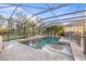 Beautiful screened pool with brick surround and lush tropical landscaping at 4509 Golden Gate Cv, Bradenton, FL 34211