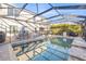 Relaxing backyard with a swimming pool, patio furniture, and screened-in enclosure at 4509 Golden Gate Cv, Bradenton, FL 34211