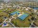 Two tennis courts with players fill this aerial view of community recreation facilities at 4509 Golden Gate Cv, Bradenton, FL 34211