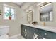 Elegant bathroom features double sinks, a marble countertop, custom cabinets, and modern lighting at 500 49Th N Ave, St Petersburg, FL 33703