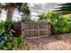 Sturdy wooden backyard gate with black hardware and framed detailing at 520 48Th N Ave, St Petersburg, FL 33703