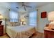 Inviting bedroom with ceiling fan, sheer curtains, and warm lighting offering a relaxing space at 520 48Th N Ave, St Petersburg, FL 33703