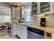 Charming kitchen featuring white cabinets, subway tile backsplash, and stainless steel dishwasher at 520 48Th N Ave, St Petersburg, FL 33703