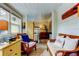 Bright sunroom with wicker furniture, wood-paneled walls, and natural light from the adjacent windows at 520 48Th N Ave, St Petersburg, FL 33703