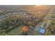 Aerial view of neighborhood park with tennis court, baseball field, and lush trees at 5914 Falconwood Pl, Lithia, FL 33547