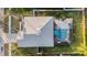 Aerial view of a home featuring a screened-in pool, backyard, and a well-maintained roof at 5914 Falconwood Pl, Lithia, FL 33547