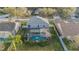 Aerial view of a well-maintained home featuring a screened-in pool and a backyard at 5914 Falconwood Pl, Lithia, FL 33547