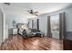 Inviting bedroom with wood floors, a gray sofa, and a unique decorative headboard at 5914 Falconwood Pl, Lithia, FL 33547