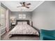 Cozy bedroom with a ceiling fan and natural light at 5914 Falconwood Pl, Lithia, FL 33547