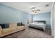 Relaxing bedroom with a comfortable sofa and a king-size bed, illuminated by natural light through the window at 5914 Falconwood Pl, Lithia, FL 33547