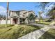 A lovely two story home featuring a lawn, landscaping, and a covered entry way with seating at 5914 Falconwood Pl, Lithia, FL 33547