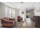 Cozy living room with stylish chairs, wood floors, and bright natural light at 5914 Falconwood Pl, Lithia, FL 33547