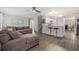 Open-concept living area with breakfast bar, stairs and kitchen in view at 5914 Falconwood Pl, Lithia, FL 33547