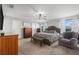 Spacious main bedroom featuring a queen bed, bench, chest of drawers, and natural light from the windows at 5914 Falconwood Pl, Lithia, FL 33547
