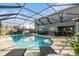 A refreshing screened-in pool with an outdoor dining area, lounge chairs and well-kept pavers at 5914 Falconwood Pl, Lithia, FL 33547