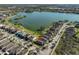 Aerial view showcasing lake, trees, and many homes in this lovely community at 6004 Sweet Birch Dr, Riverview, FL 33578