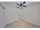 Bedroom with tan carpeting, ceiling fan, and white trim is move-in ready at 6004 Sweet Birch Dr, Riverview, FL 33578