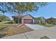 Charming single-Gathering home featuring a well-manicured lawn and an attached two-car garage at 6004 Sweet Birch Dr, Riverview, FL 33578