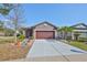 Charming single-story home with a well-manicured lawn, mature landscaping and a two car garage at 6004 Sweet Birch Dr, Riverview, FL 33578