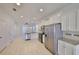 Bright open kitchen and dining area with stainless steel appliances and tile flooring at 6004 Sweet Birch Dr, Riverview, FL 33578