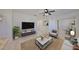Bright living room with neutral décor, ceiling fan, and a view of the dining area at 6004 Sweet Birch Dr, Riverview, FL 33578