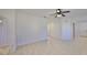 Neutral living room featuring tile flooring, a ceiling fan, and access to other areas of the home at 6004 Sweet Birch Dr, Riverview, FL 33578