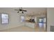 Bright living room open to kitchen, featuring a ceiling fan and tiled floor at 6004 Sweet Birch Dr, Riverview, FL 33578