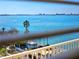 Balcony view of the sparkling blue water and distant skyline, complemented by lush greenery at 6075 Shore S Blvd # 605, Gulfport, FL 33707