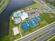 Aerial view of community amenities including a pool, tennis courts, and a playground at 6135 Voyagers Pl, Apollo Beach, FL 33572