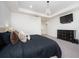 Bright main bedroom featuring tray ceiling, chandelier, TV, and neutral colors at 6135 Voyagers Pl, Apollo Beach, FL 33572