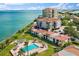 Aerial view of complex offering a pool, manicured grounds, and stunning waterfront access at 6268 Palma Del Mar S Blvd # 101, St Petersburg, FL 33715