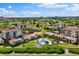 Expansive aerial shot of a resort-style property featuring a pool and lush landscaping at 6268 Palma Del Mar S Blvd # 101, St Petersburg, FL 33715
