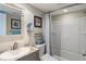 Updated bathroom with a modern vanity, framed mirror, and a shower-tub combination with a stylish curtain at 6268 Palma Del Mar S Blvd # 101, St Petersburg, FL 33715