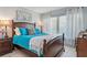 Bright bedroom featuring tile floors and a wooden bed frame with vibrant blue bedding at 6268 Palma Del Mar S Blvd # 101, St Petersburg, FL 33715