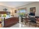 Comfortable bedroom with a wooden bed frame, desk area, and a view of lush greenery outside the window at 6268 Palma Del Mar S Blvd # 101, St Petersburg, FL 33715