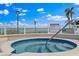 Community hot tub and deck overlooking the ocean with spa rules sign at 6268 Palma Del Mar S Blvd # 101, St Petersburg, FL 33715