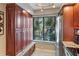 Kitchen featuring custom wood cabinets, granite counters, and a built-in bench under a garden window at 6268 Palma Del Mar S Blvd # 101, St Petersburg, FL 33715
